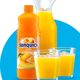 Sunquick concentrate with pitcher & glasses on blue background